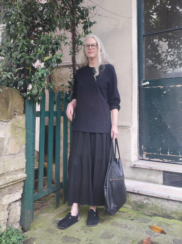 A black long-sleeve Organic Cotton T-shirt worn with quiet confidence and effortless style