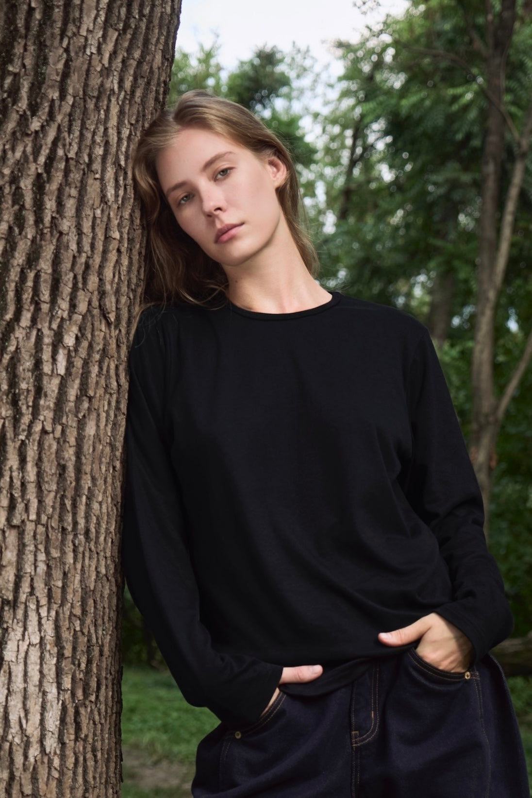 AURETEMPHE long sleeve t-shirt in black organic cotton, unisex fit, shown on female model.