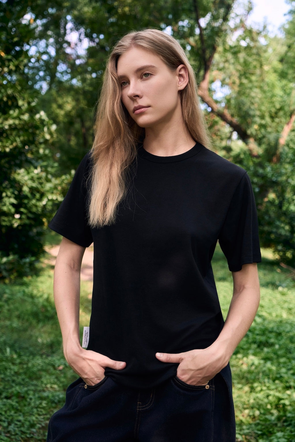AURETEMPHE short sleeve t-shirt in black organic cotton, unisex fit, shown on female model.