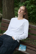 AURETEMPHE long sleeve t-shirt in white organic cotton, unisex fit, shown on female model.