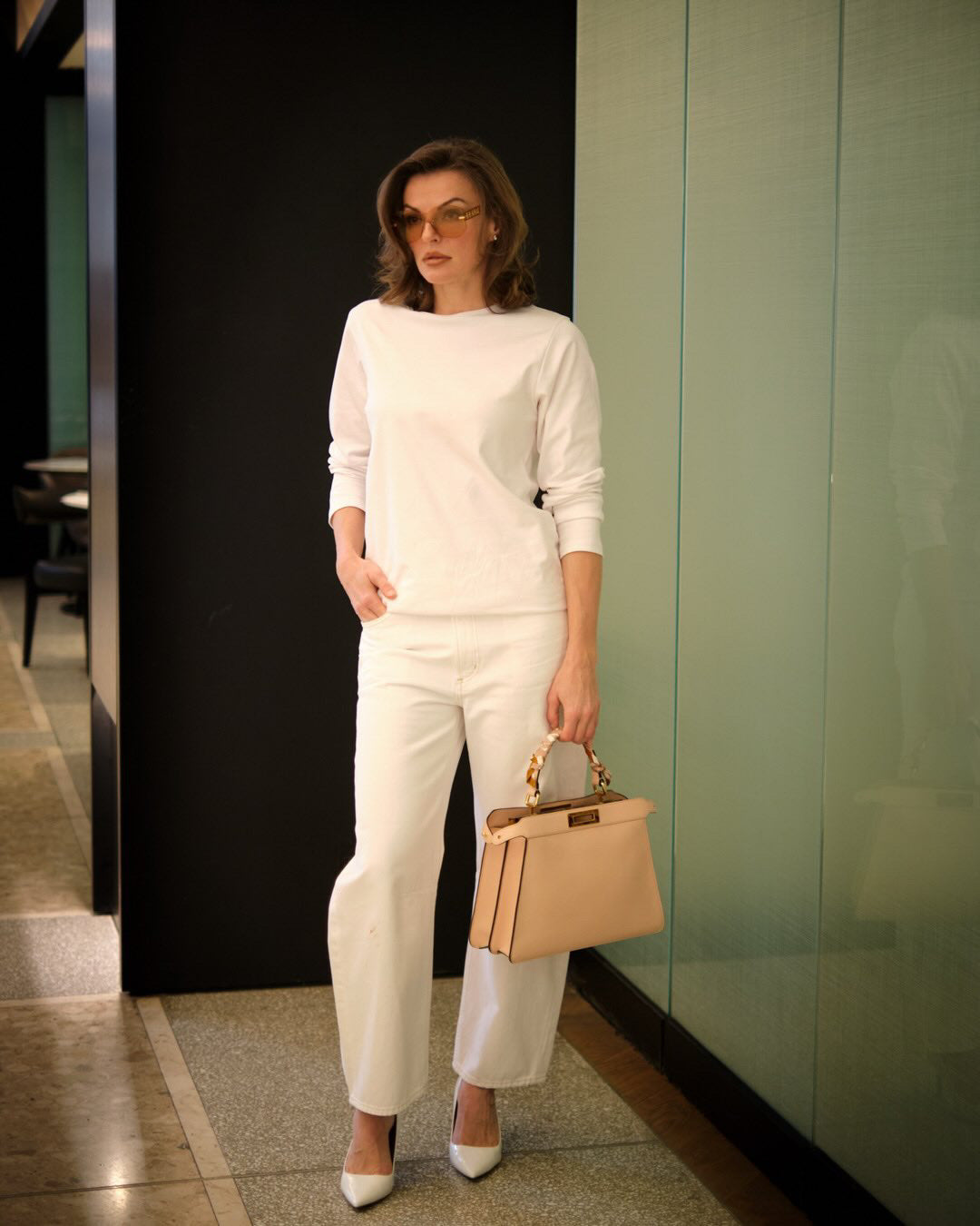White long-sleeve organic cotton T-shirt styled in a clean all-white outfit